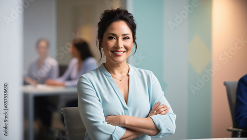 woman boss in the office wide smile arms crossed office background