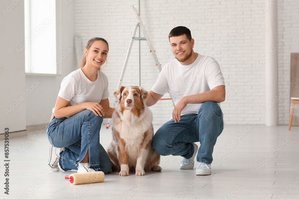 Happy young couple with cute dog planning repair of their new house Happy young couple with cute dog planning repair of their new house