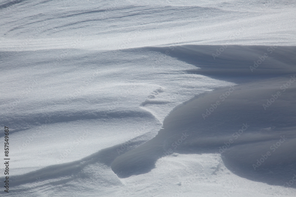 Naklejka premium Fresh White Wintery Wind Blown Snow Drifts Background Image With Highlights and Shadows