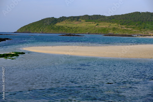 beautiful landscape of Hamdeok beach and Seoubong peak in Jeju island, South Korea