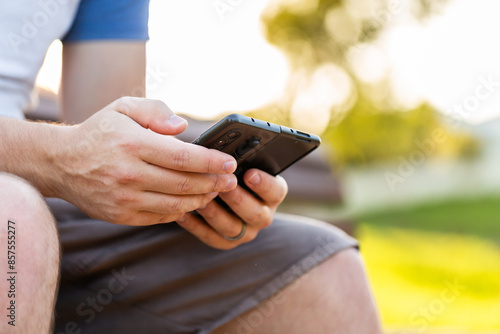 Person sitting outside with fold phone 