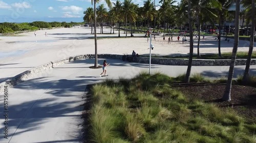 path to the beach riding skater girl top view from drone