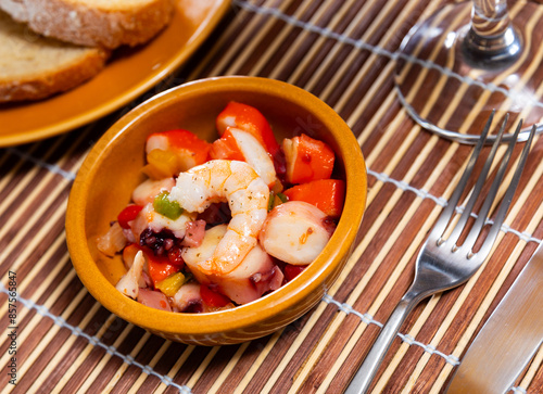 Appetizing salpicao salad of seafood and vegetables served on platter photo