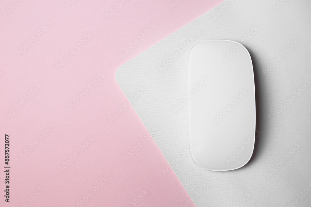 One wireless mouse with mousepad on pink background, top view. Space for text One wireless mouse with mousepad on pink background, top view. Space for text