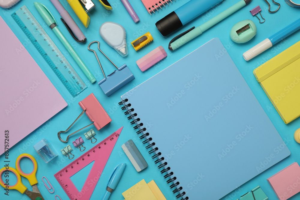 Flat lay composition with notebook and different stationery on light blue background Flat lay composition with notebook and different stationery on light blue background