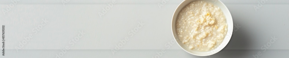 Minimalistic Display of Porridge in a White Bowl Against a Pristine White Background Minimalistic Display of Porridge in a White Bowl Against a Pristine White Background