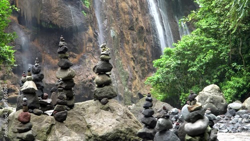 Goa Tetes waterfall surrounded by a forest, rocks stacked in a natural landscape. Java Island, Lumajang Province photo