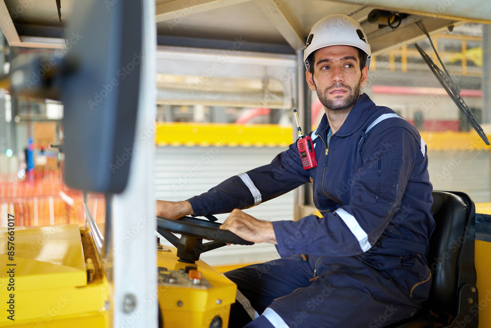 Engineer or worker driving a car in the factory Engineer or worker driving a car in the factory