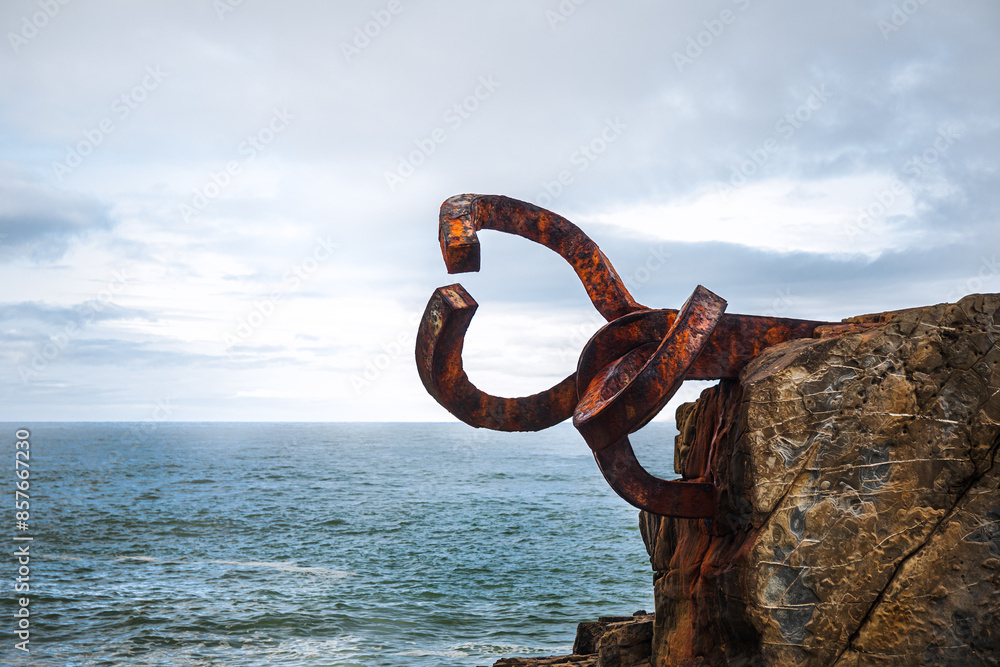 Fototapeta premium Rusty sculpture Peine del viento at San Sebastian's shore 