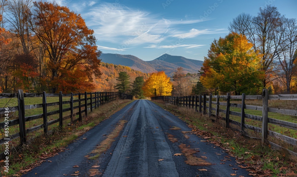 A charming rural road lined with old wooden fences and trees in full autumn colors, leading towards distant mountains A charming rural road lined with old wooden fences and trees in full autumn colors, leading towards distant mountains