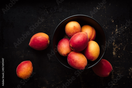 Fresh apricots in bowl.