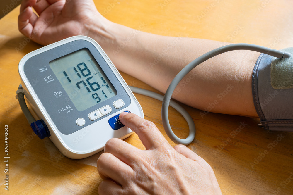man check blood pressure monitor and heart rate monitor with digital pressure gauge. Health care and Medical concept man check blood pressure monitor and heart rate monitor with digital pressure gauge. Health care and Medical concept