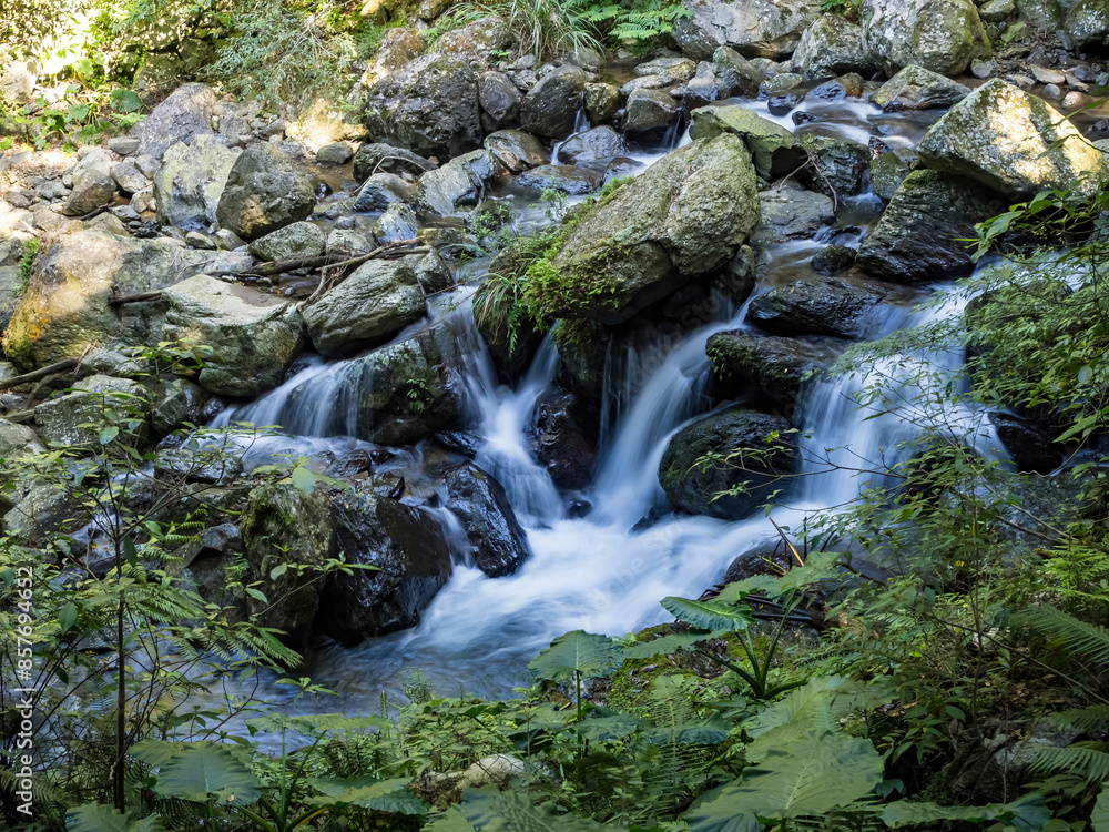 Fresh water in a stream finding a way down over rocks in slow motion Fresh water in a stream finding a way down over rocks in slow motion