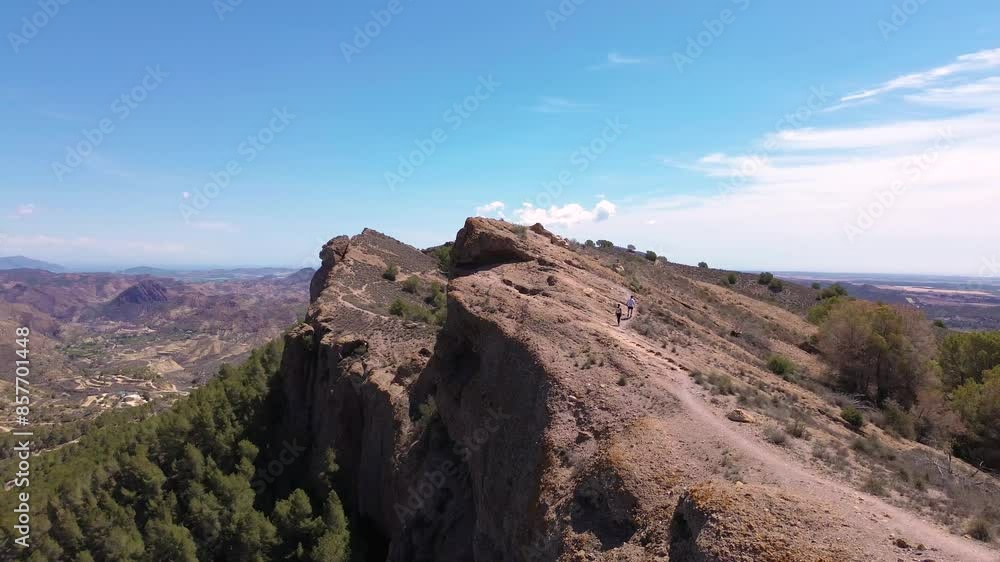 hiking friends through mountains at sunset drone view point. Drone aerial view at sunset in Murcia mountain, valley, travel destination from Europe, Spain hiking friends through mountains at sunset drone view point. Drone aerial view at sunset in Murcia mountain, valley, travel destination from Europe, Spain