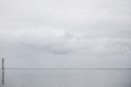 Dark storm clouds over a quiet ocean