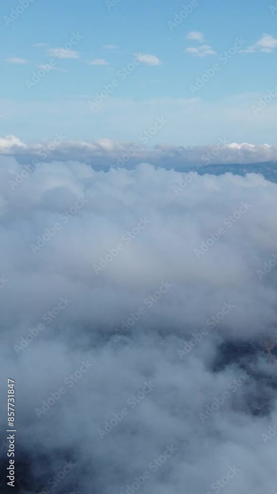Aerial vertical view. High above thick fog, like beautiful ocean of clouds at sunrise. Sun is rising above endless sea of clouds until horizon. Amazing nature landscape. Climate and weather change Aerial vertical view. High above thick fog, like beautiful ocean of clouds at sunrise. Sun is rising above endless sea of clouds until horizon. Amazing nature landscape. Climate and weather change