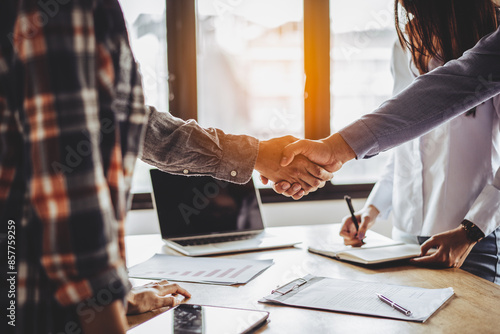 Фотография Two businessmen handshaking in meeting after final project agreement deal done