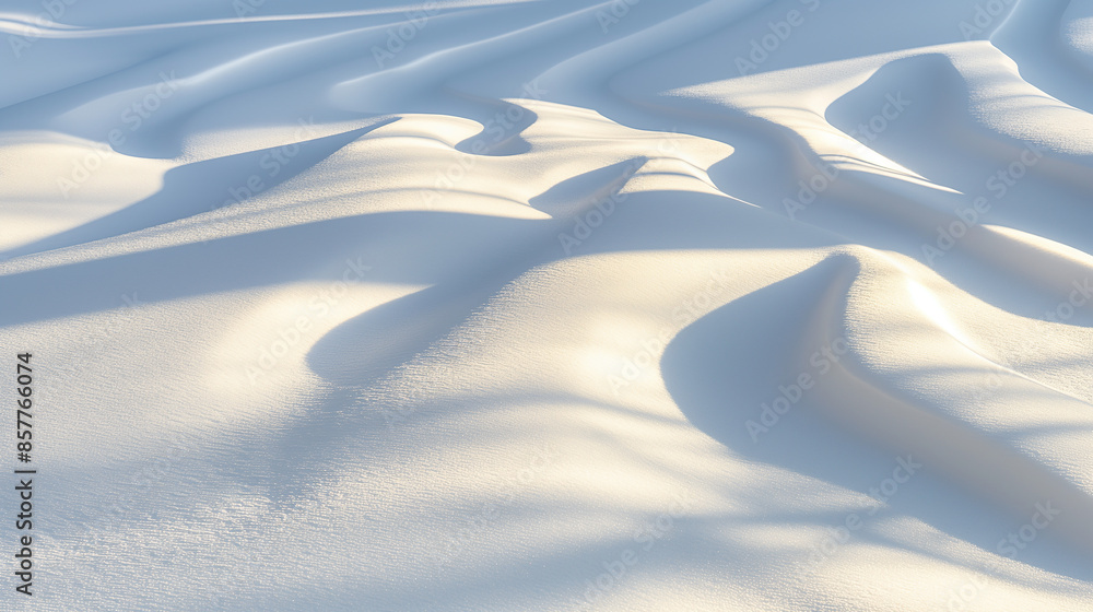 Sunlight creating shadows on untouched smooth snow covered landscape Sunlight creating shadows on untouched smooth snow covered landscape