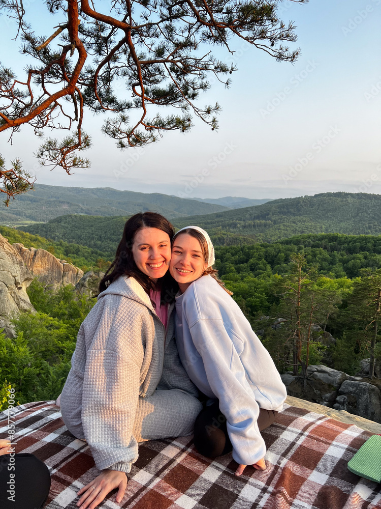 happy couple women friends taking picture on sunset