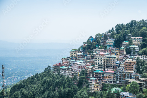 A city on top of a hill with numerous buildings and a scenic view of the horizon, Dharamsala, India