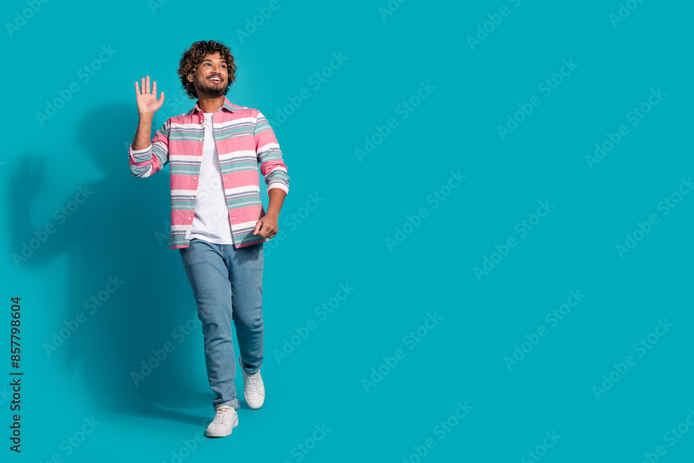 Photo of funny positive nice man wear stylish striped clothes look empty space isolated on cyan color background Photo of funny positive nice man wear stylish striped clothes look empty space isolated on cyan color background