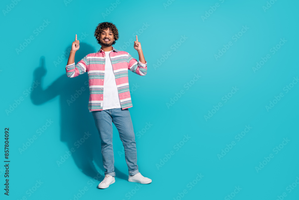 Photo of nice positive man wear stylish striped clothes introduce empty space poster isolated on cyan color background Photo of nice positive man wear stylish striped clothes introduce empty space poster isolated on cyan color background