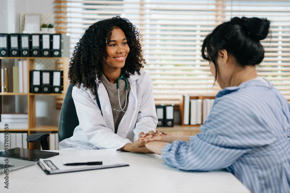 Asia female doctor using clipboard is delivering great news talk discuss results or symptoms with female patient Asia female doctor using clipboard is delivering great news talk discuss results or symptoms with female patient