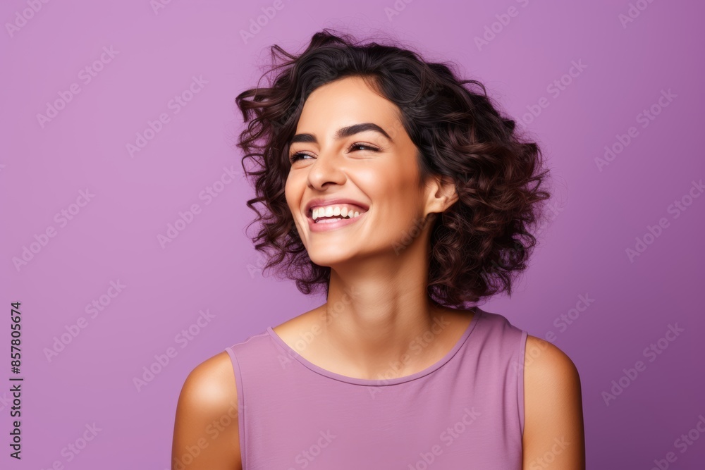 Portrait photo of a friendly Hispanic woman, winking on a pastel violet background
Portrait photo of a friendly Hispanic woman, winking on a pastel violet background