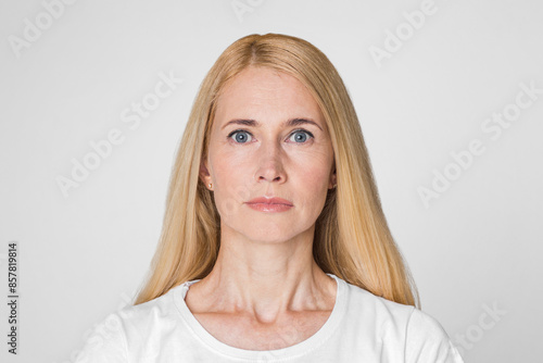 Принти на полотні This image shows a woman with blonde hair looking directly at the camera with a neutral expression
