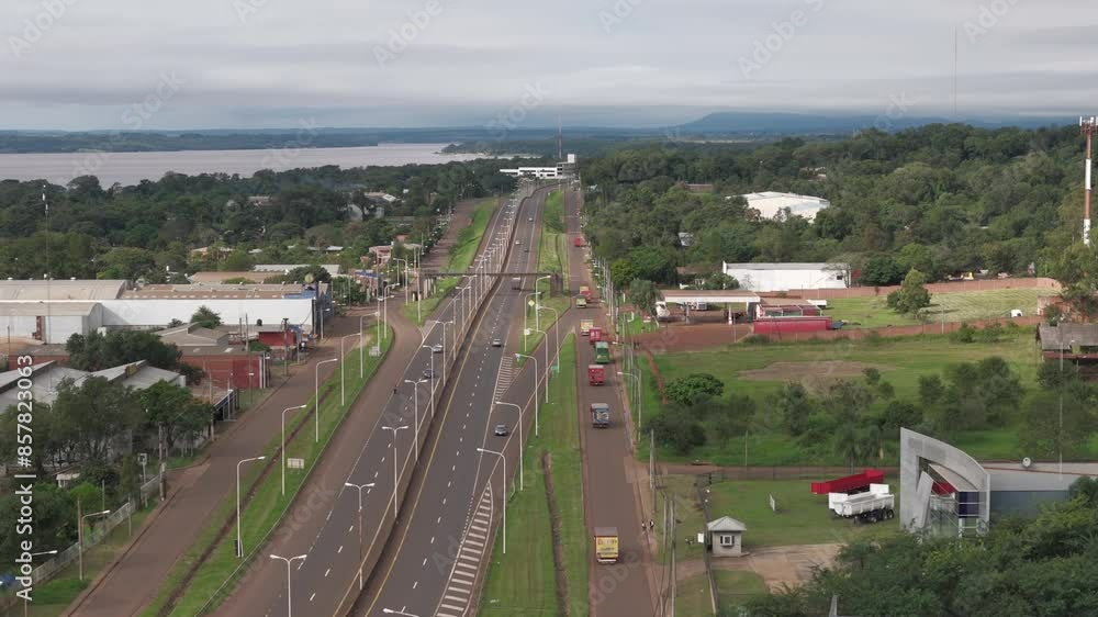 Aerial perspective of the main road Route 12 and collector in Posadas, Misiones, Argentina, highlighting the city's transportation network. Aerial perspective of the main road Route 12 and collector in Posadas, Misiones, Argentina, highlighting the city's transportation network.
