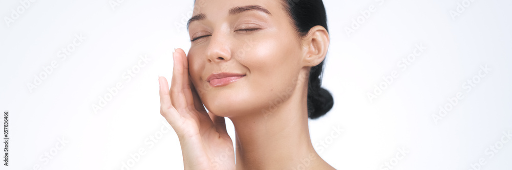 Asian Woman with Perfect Skin Smiling and Touching Face with Closed Eyes Asian Woman with Perfect Skin Smiling and Touching Face with Closed Eyes
