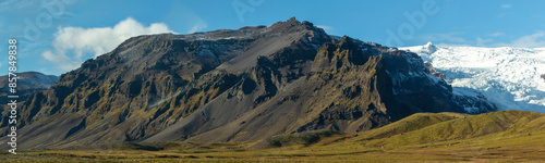 A mountain range with snow on top and a rocky hillside