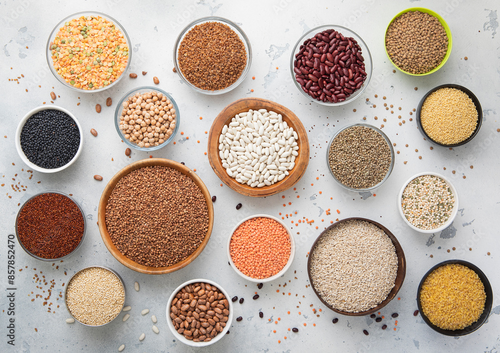 Top view of bowls with various healthy cereals. Bulgur,beans,quinoa,pea,couscous and hemp with chickpea and buckwheat seed on light kitchen background.Macro. Top view of bowls with various healthy cereals. Bulgur,beans,quinoa,pea,couscous and hemp with chickpea and buckwheat seed on light kitchen background.Macro.