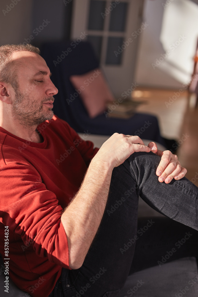 Fototapeta premium Man with knee pain at home.
