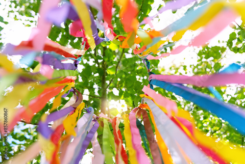 Photos colorful ribbons hanging on tree, abstract natural background