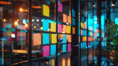 In the office, business people use post-its to share ideas. Product brainstorm. Sticky note on glass wall or blackboard. Various colors. photo