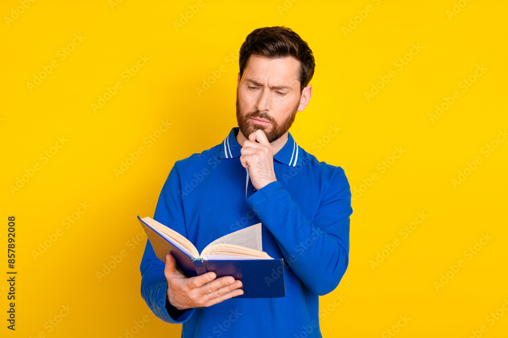 Photo portrait of pretty young male read minded book wear trendy blue outfit isolated on yellow color background Photo portrait of pretty young male read minded book wear trendy blue outfit isolated on yellow color background