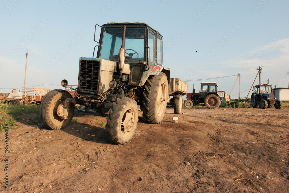 A Rusty Tractor Stands Tall in a Rural Field on a Sunny Day A Rusty Tractor Stands Tall in a Rural Field on a Sunny Day