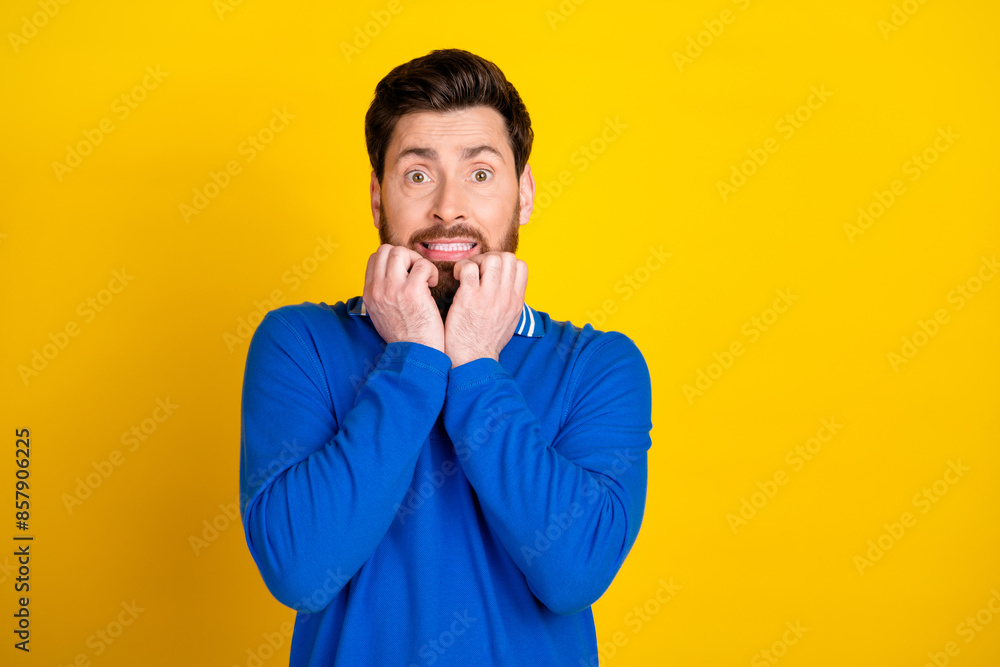 Photo portrait of pretty young male frightened reaction wear trendy blue outfit isolated on yellow color background Photo portrait of pretty young male frightened reaction wear trendy blue outfit isolated on yellow color background