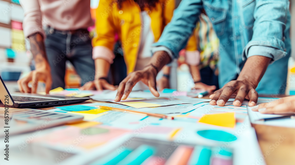 Fototapeta premium A collaborative team working with colorful documents on a table, concept of teamwork and planning. Generative AI