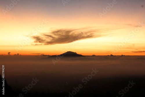 Wallpaper Mural 
A majestic sunrise over the mountains, a fine expanse of mist, an orange morning sky Torontodigital.ca