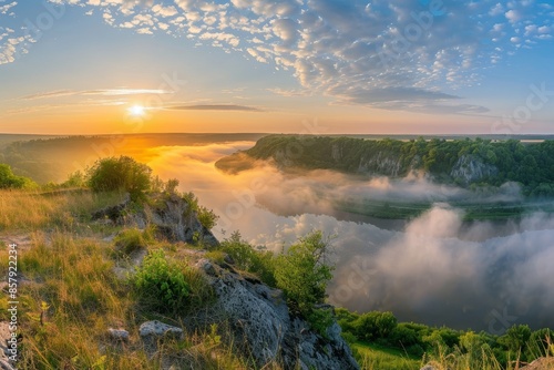 Tranquil summer sunrise panorama with river, fog, and sunlight on a beautiful sunny day