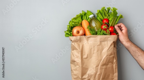 Healthy Nutrition Concept. Mature Man Holding Paper Bag With Groceries In Kitchen Interior