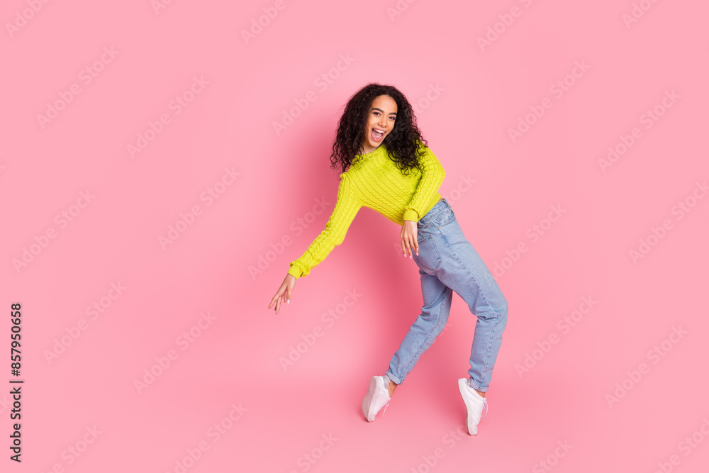 Photo portrait of teenage carefree girl brunette curly hair having fun dancing at disco near empty space isolated on pink color background Photo portrait of teenage carefree girl brunette curly hair having fun dancing at disco near empty space isolated on pink color background