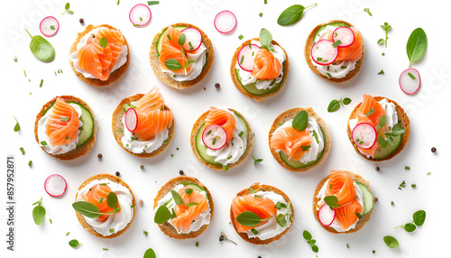 Tasty canapes with salmon, cucumber, radish and cream cheese isolated on white, top view