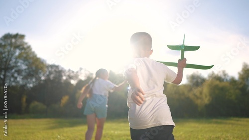 Canvas Print A child runs away from an airplane with a toy
