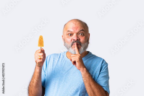 Asian Indian senior old elderly man eating kulfi photo