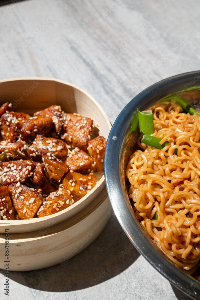 Fototapeta premium noodle bento in metal bowl and sesame chinese chicken