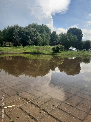 Obraz na płótnie Big puddle in the city yard after heavy rain at summer day in East Europe w salonie