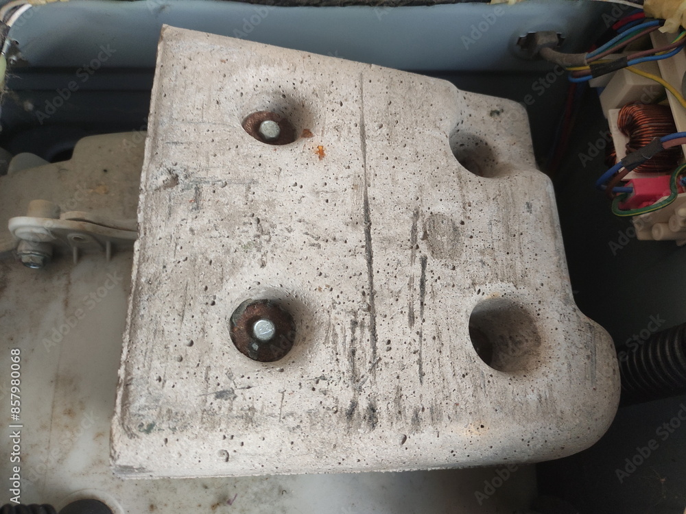 Top big counterweight inside front load washing machine closeup